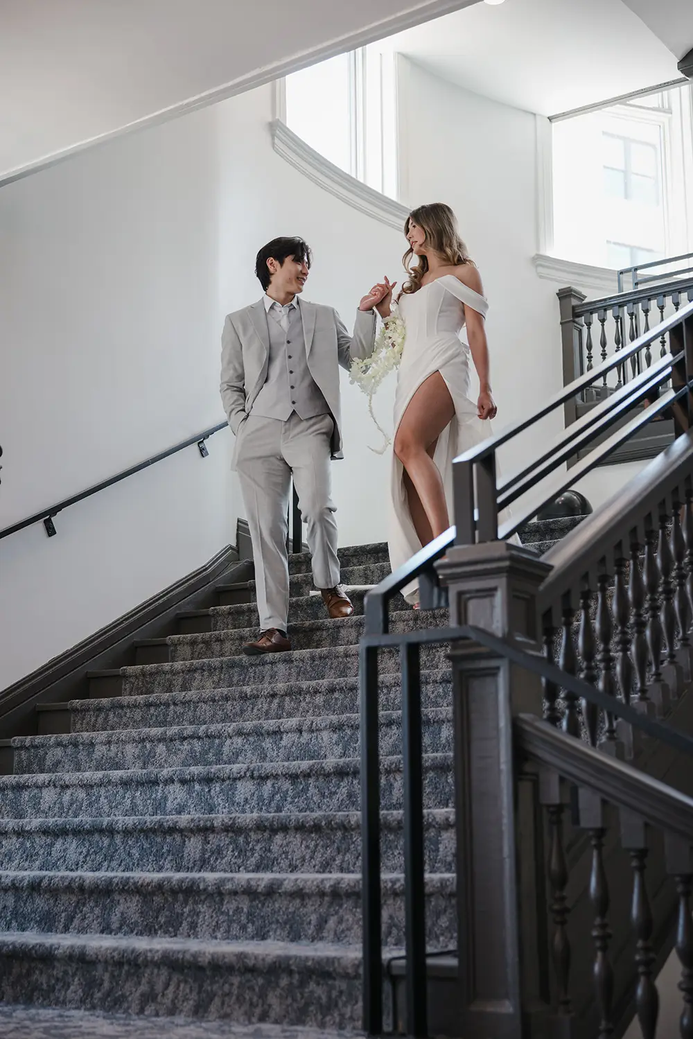 Groom and bride walk down the stairs