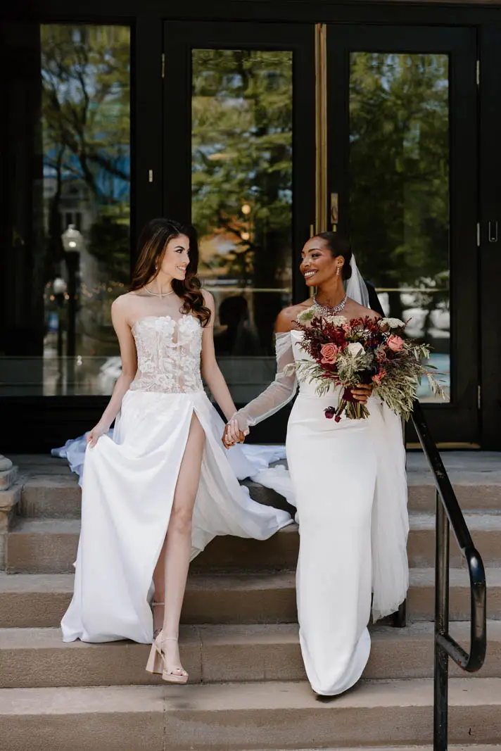 brides posing outside of building