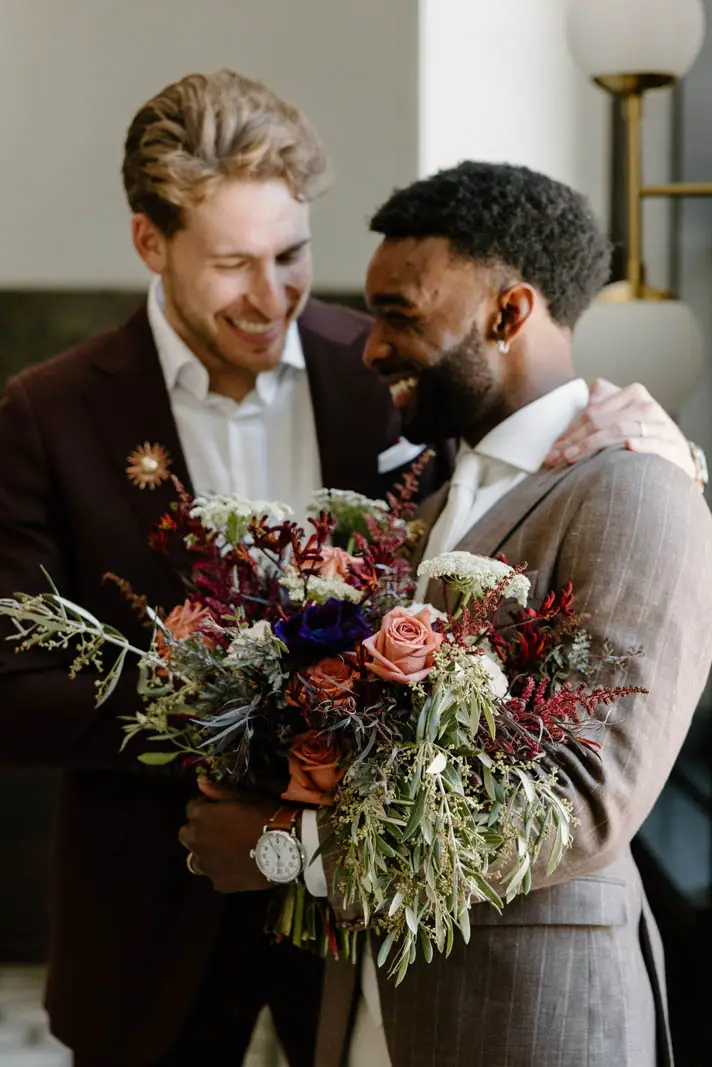 men holding flower bouquet