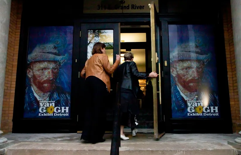 people walking into building
